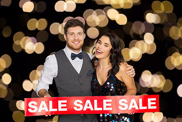 Image showing happy couple with red sale sign