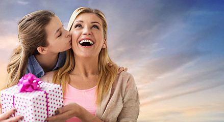 Image showing daughter kissing mother and giving her present