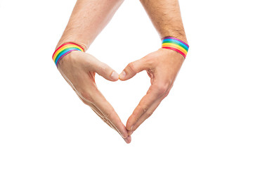 Image showing male hands with gay pride wristbands showing heart