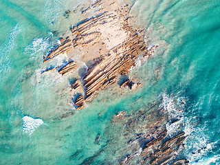 Image showing Rocks being swallowed up by the ocean