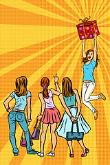 Image showing Women shoppers look at the girl with a gift
