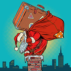 Image showing Santa Claus with a suitcase climbs into the chimney