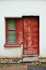 Image showing White wall with red window and door