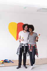 Image showing couple with painted heart on wall