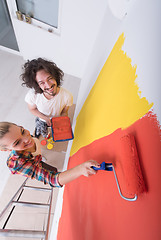 Image showing couple painting interior wall