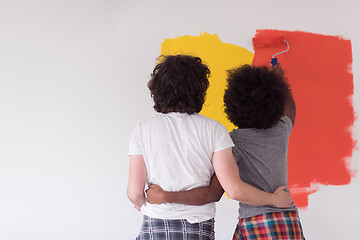 Image showing multiethnic couple painting interior wall