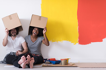 Image showing young multiethnic couple playing with cardboard boxes