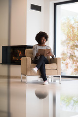 Image showing black woman at home reading book