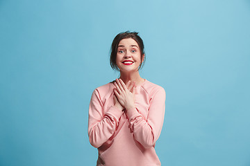 Image showing Beautiful woman looking suprised isolated on blue