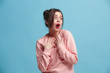 Image showing Beautiful woman looking suprised isolated on blue