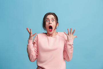 Image showing Beautiful woman looking suprised isolated on blue