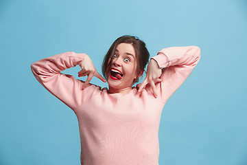 Image showing The squint eyed woman with weird expression isolated on blue