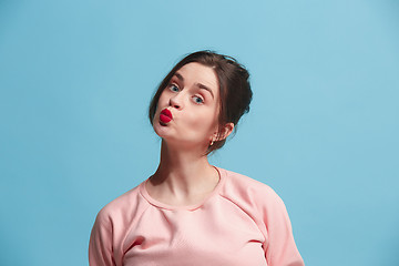 Image showing Portrait of attractive cute girl with bright makeup with kiss isolated over blue background