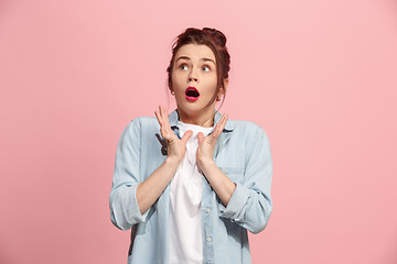 Image showing Beautiful woman looking suprised isolated on pink