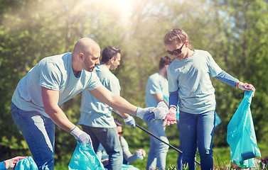 Image showing volunteers with garbage bags cleaning park area