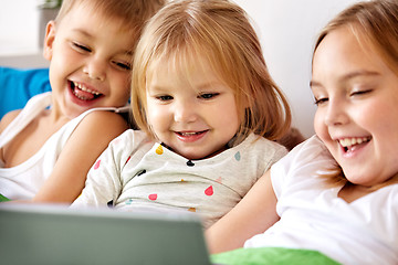 Image showing happy little kids with tablet pc in bed at home