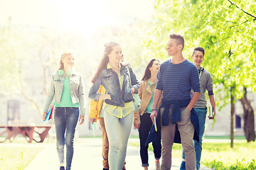 Image showing group of happy teenage students walking outdoors