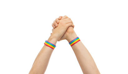 Image showing hands with gay pride wristbands in winning gesture