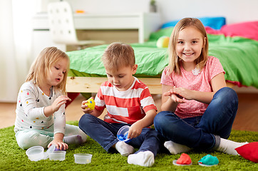 Image showing kids with modelling clay or slimes at home