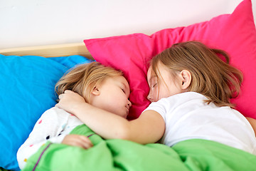 Image showing happy little girls sleeping in bed at home