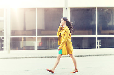 Image showing smiling young woman or girl calling on smartphone