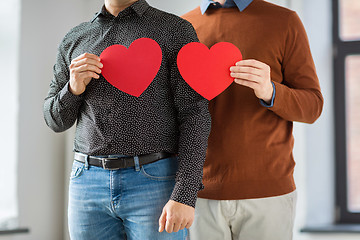 Image showing close up of happy male couple holding red hearts