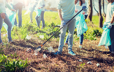 Image showing volunteers with garbage bags cleaning park area