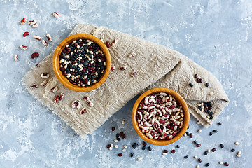 Image showing Different types of beans in wooden bowls.