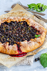 Image showing Homemade galette with black currant and lemon zest.