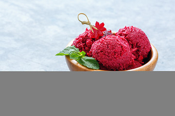 Image showing Artisanal beetroot ice cream in a wooden bowl.