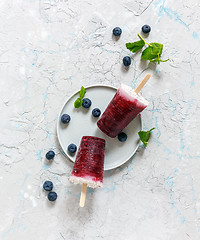 Image showing Homemade coconut popsicles with fresh berry. 