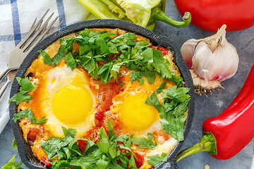 Image showing Shakshuka in a cast iron pan closeup.