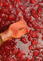 Image showing Raspberry jam and wooden blade