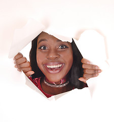 Image showing Smiling woman looking trough hole