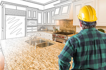 Image showing Male Contractor with Hard Hat Looking At Custom Kitchen Drawing 