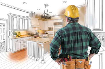 Image showing Male Contractor with Hard Hat and Tool Belt Looking At Custom Ki