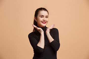 Image showing The happy business woman standing and smiling against pastel background.