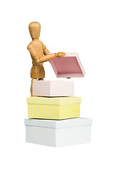 Image showing Wooden mannequin opens little box