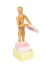 Image showing Wooden mannequin with gift box