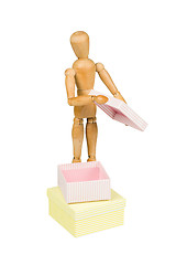 Image showing Wooden mannequin opens little box
