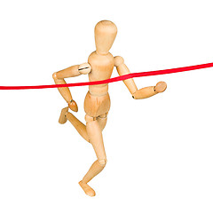 Image showing Wooden mannequin running through finishing line