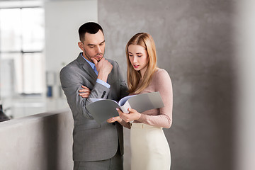 Image showing businesswoman and businessman with folder