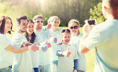 Image showing group of volunteers taking picture by smartphone