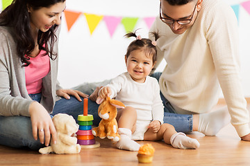 Image showing baby girl with parents playing with toy rabbit