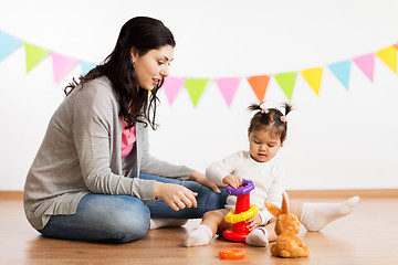 Image showing mother and baby daughter playing with pyramid toy