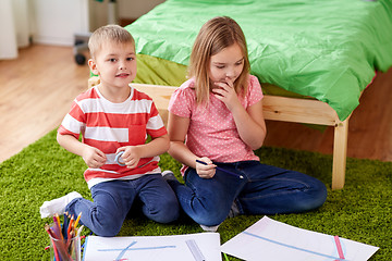 Image showing happy kids drawing at home