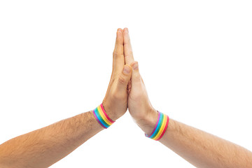 Image showing hands with gay pride wristbands make high five