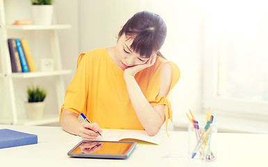 Image showing bored asian woman student with tablet pc at home