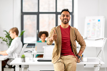 Image showing smiling indian man showing thumbs up at office