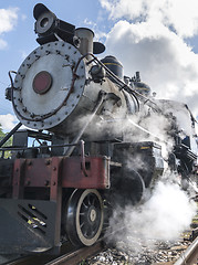 Image showing Old steam locomotive or railway train arriving 